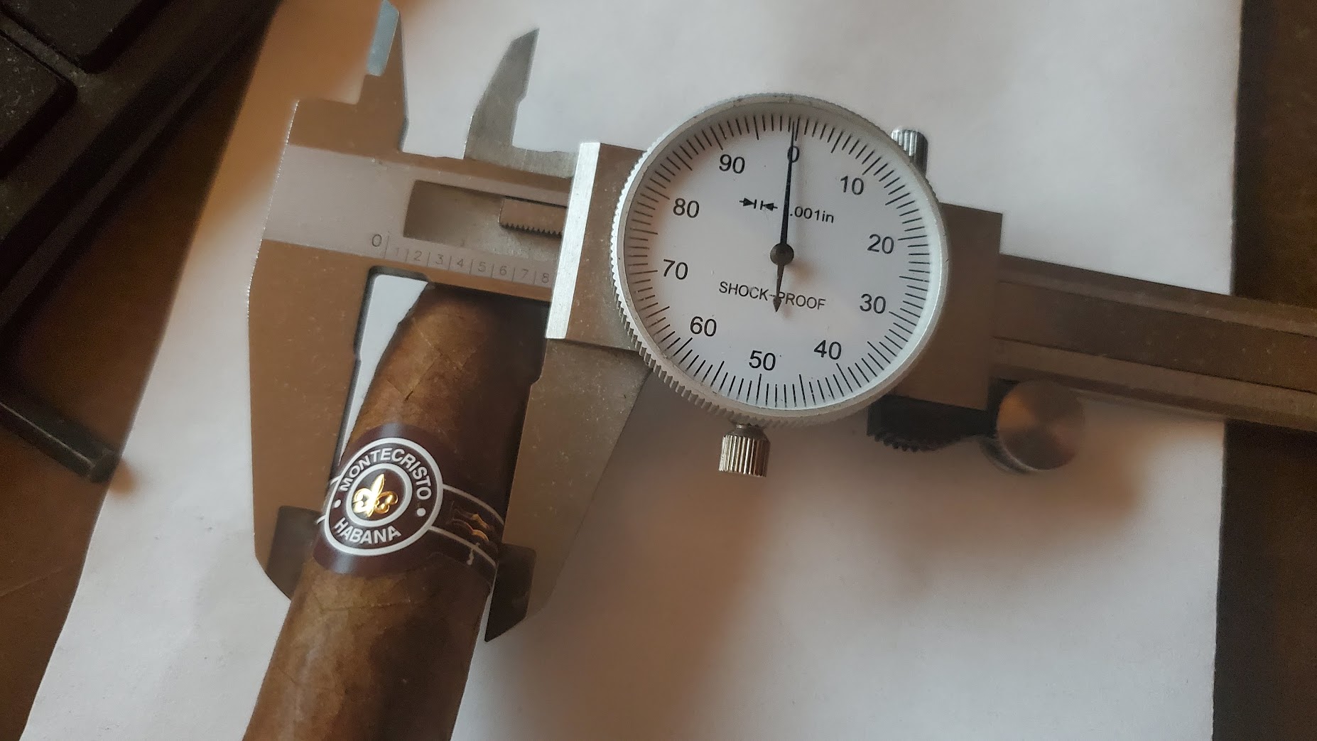 Dial caliper measuring the ring gauge of a Montecristo cigar